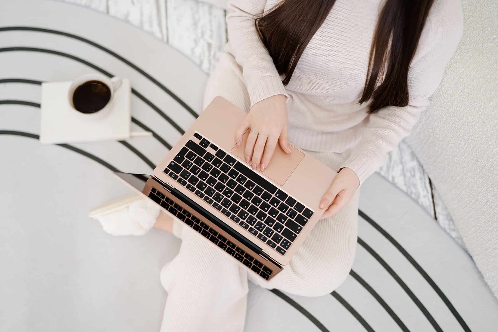 A woman is sitting on the floor with a laptop. A woman is sitting on the floor with a laptop.