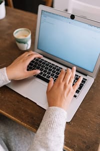 woman typing on laptop